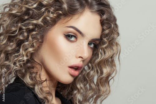 Nice model woman with curly hair on white, fashion beauty portrait