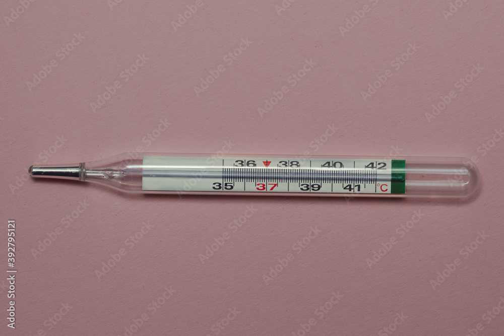 mercury thermometer for measuring temperature on a pink background mercury thermometer for measuring temperature on a pink background