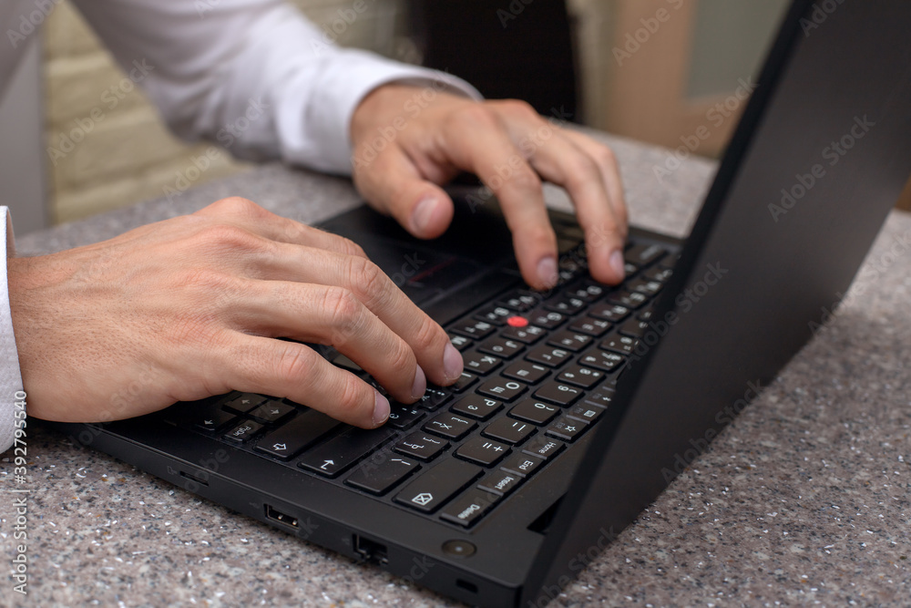 young serious man working on a laptop at home young serious man working on a laptop at home