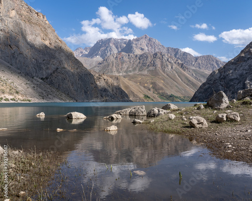 Turquoise blue Marguzor lake in scenic mountain landscape in the seven lakes area, Shing river valley, near Penjikent or Panjakent, Sughd, Tajikistan photo