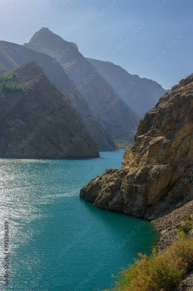 Turquoise blue Marguzor lake in scenic mountain landscape in the seven lakes area, Shing river valley, near Penjikent or Panjakent, Sughd, Tajikistan