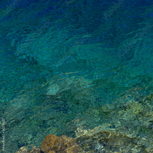 Abstract image of quiet ripples in the pure water of translucent turquoise mountain lake in Marguzor  Tajikistan