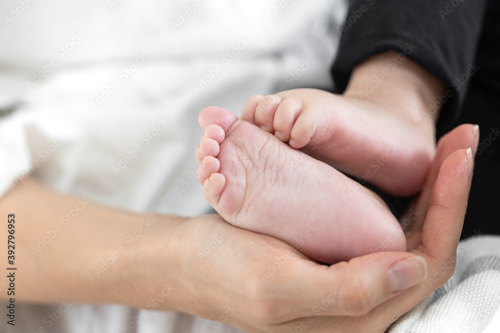 Feet of a newborn baby in the hand of mom. Happy family concept. Feet of a newborn baby in the hand of mom. Happy family concept.