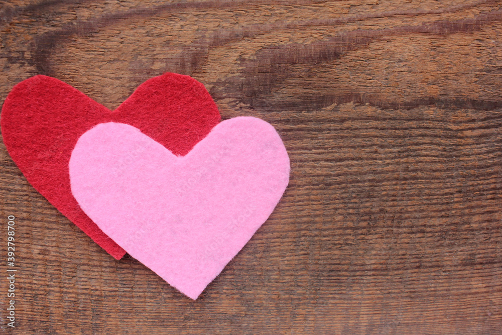 Red and pink hearts made of felt fabric on wooden background. Flat lay valentine`s day composition. Copy space Red and pink hearts made of felt fabric on wooden background. Flat lay valentine`s day composition. Copy space