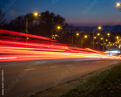Red traffic lights shot at long exposure going downhill. © Matt