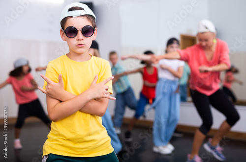 Portrait of boy hip hop dancer exercising with friends at dance class © JackF
