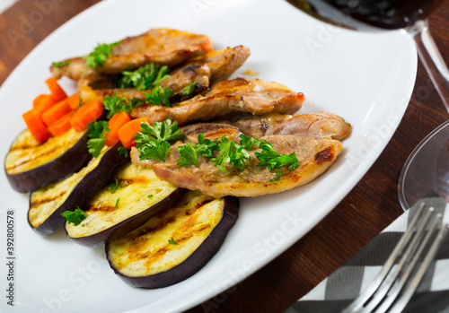 Tender slices of mutton chops served with grilled vegetables and parsley on plate