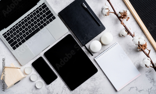 Modern office desktop with mobile devices and notebooks