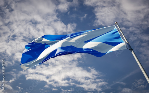 Scotland national flag waving at sky background close-up.