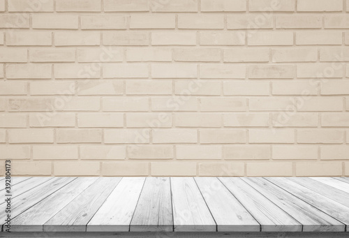 Empty wooden table top on cream brick wall background, Design wood terrace white. Perspective for show space for your copy and branding. Can be used as product display montage. Vintage style concept.