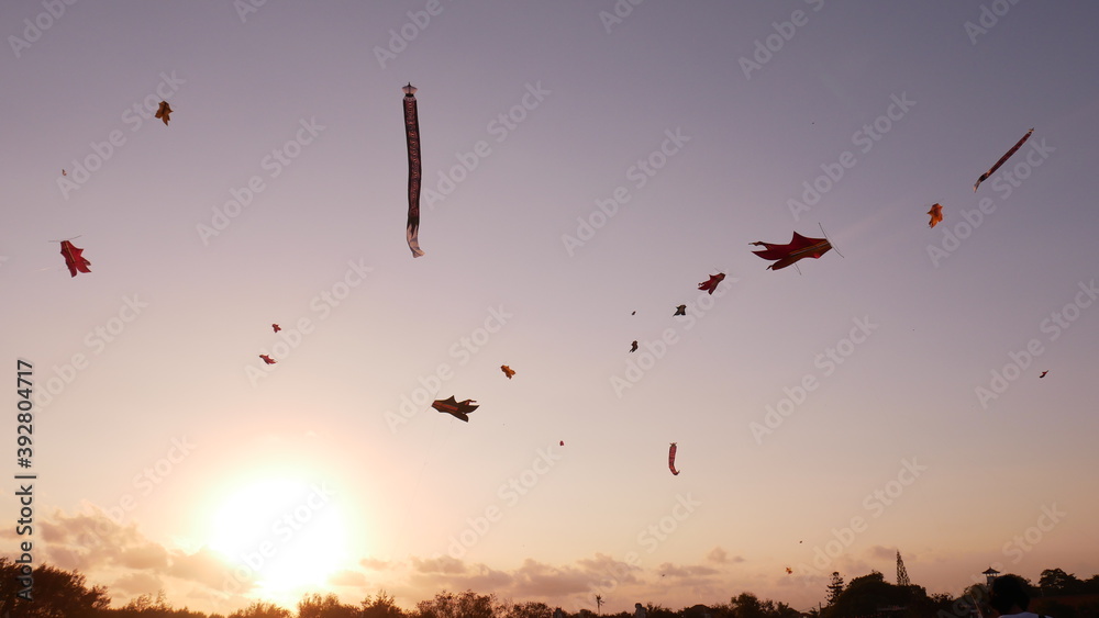 playing big kites. decorating the sky and enjoying the sunset on the beach of mertasari bali