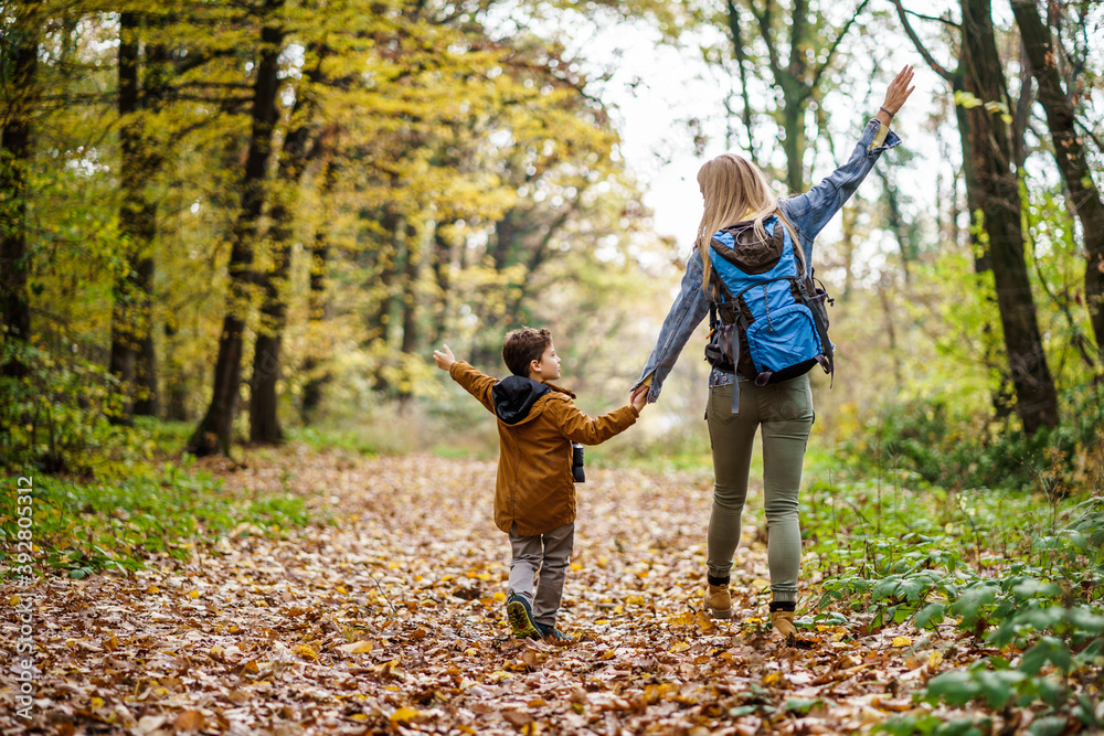 Happy mother and son are hiking in forest. Happy mother and son are hiking in forest.