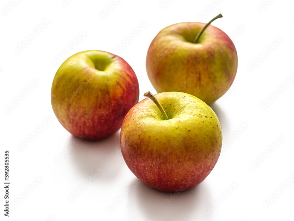 Three seasonal apples, red-yellow color, on a white background Three seasonal apples, red-yellow color, on a white background