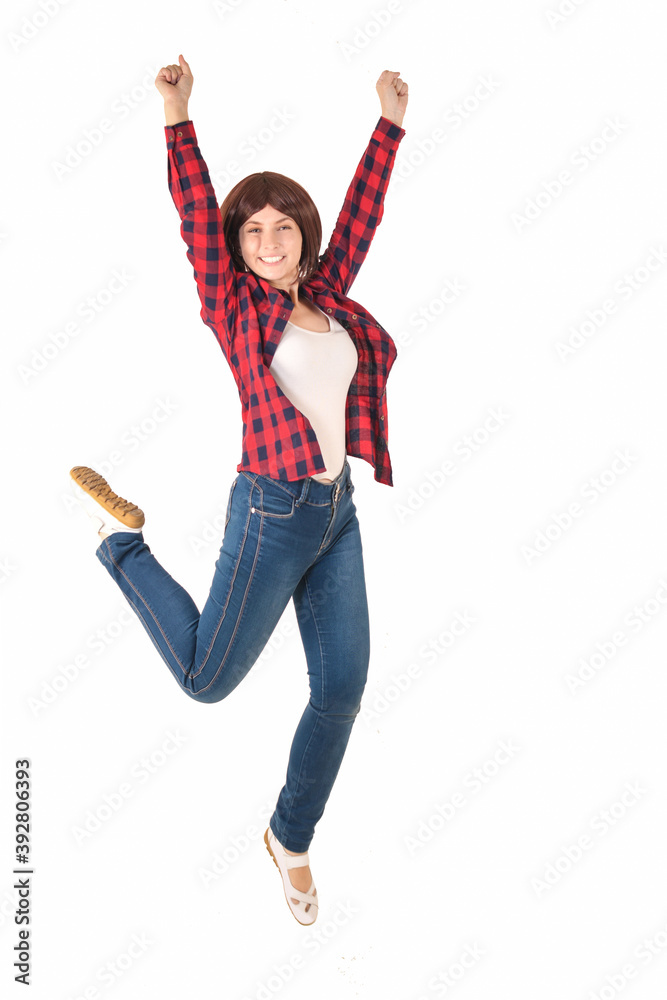Happy full length young girl in red checked shirt with short hair jumps for joy isolated on white Happy full length young girl in red checked shirt with short hair jumps for joy isolated on white