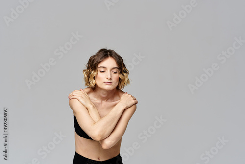 Sporty woman in leggings on a gray background is engaged in fitness Copy Space