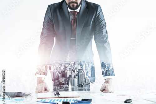 Businessman in suit and tie standing near desk