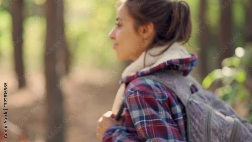 traveler casual style woman walks in woods with backpack, single hiking in autumn forest. Concept hiking people in nature traveler casual style woman walks in woods with backpack, single hiking in autumn forest. Concept hiking people in nature