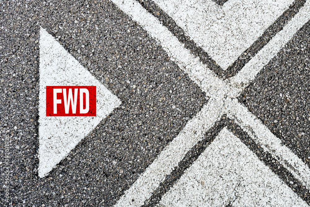The abbreviation forward (fwd) written on asphalt road with direction arrows. Moving forward concept.