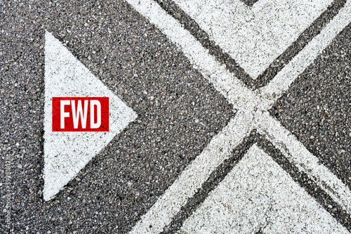 The abbreviation forward (fwd) written on asphalt road with direction arrows. Moving forward concept. © Cagkan