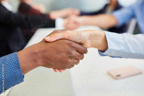Handshake between Europeans and Africans in the office