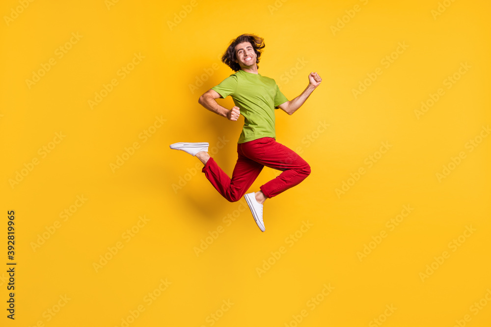 Full length body size side profile photo of jumping high man hurrying on sale isolated on vibrant yellow color background