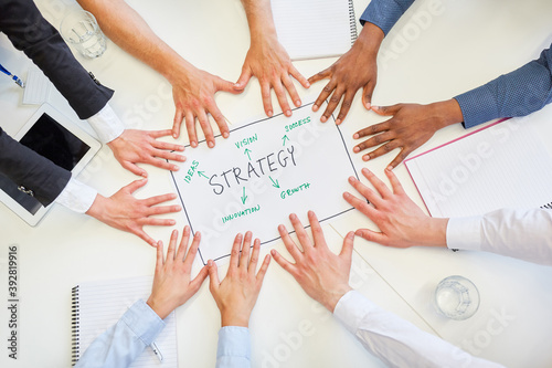 Hands together holding strategy plan in meeting