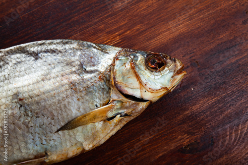 Closeup of air-dried salted freshwater bream on wooden background.. photo