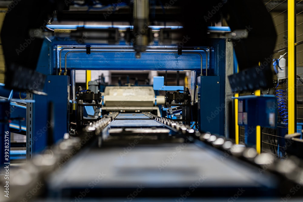 Empty Production line in factory, with yellow safety fence, conveyor belt automated production line