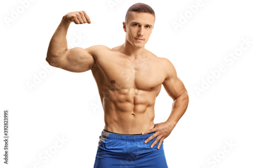 Foto Topless young muscular man flexing a biceps muscle
