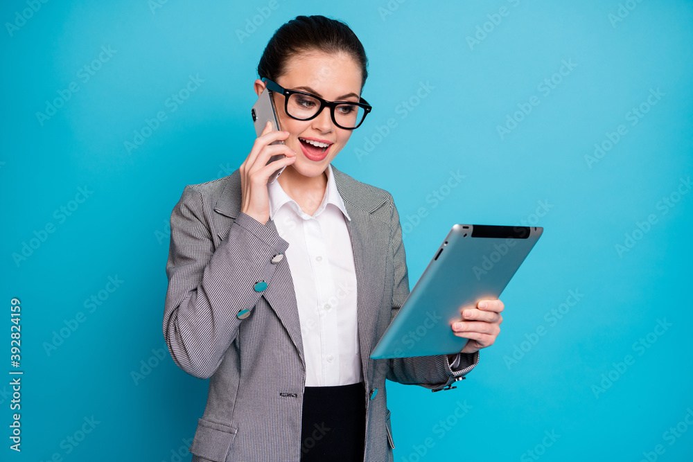 Yes boss i get document. Girl use smartphone call talk look tablet wear blazer isolated blue color background Yes boss i get document. Girl use smartphone call talk look tablet wear blazer isolated blue color background