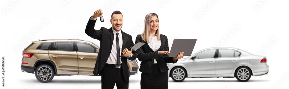 Young professional man and woman with a laptop computer and a SUV behind them