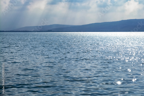 Sun reflecting on sparkling blue sea