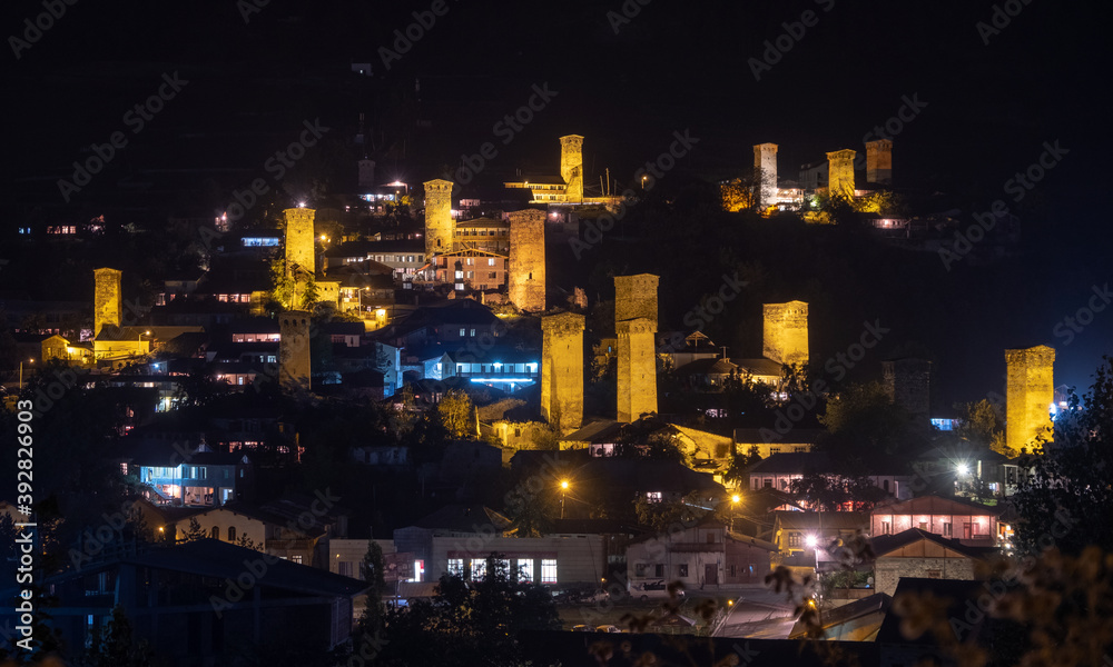 Night panoramic view of a highland townlet Mestia with illuminated svan towers, Svaneti, Georgia.