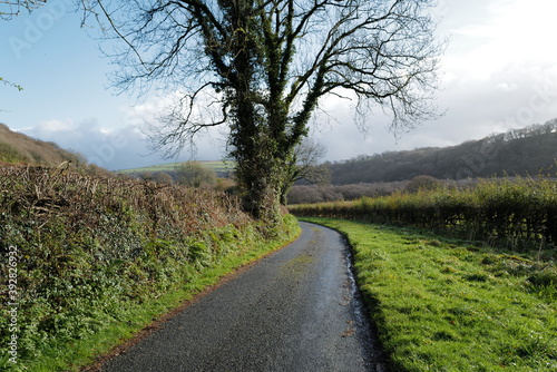 Small country road in Wales with valley and hills in the distance - shot in autumn