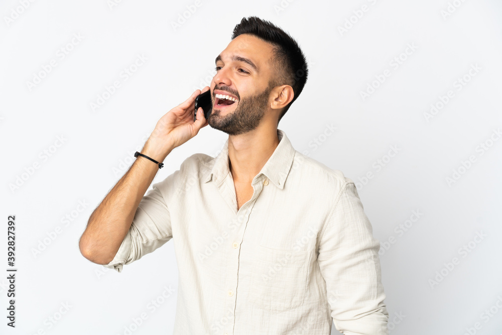 Young caucasian man isolated on white background keeping a conversation with the mobile phone with someone Young caucasian man isolated on white background keeping a conversation with the mobile phone with someone
