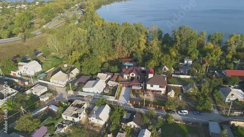 Beautiful cottage from the air. Summer cottages near the lake. Flying over the cottages next to the lake photo