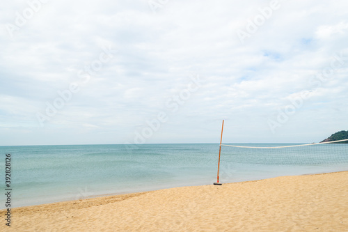 Fototapeta Naklejka Na Ścianę i Meble -  Beach volleyball net on fine sand with blue sea
