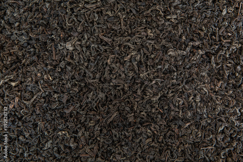 Dry black tea leaves texture background.