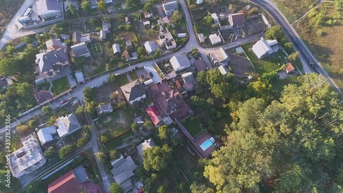 Beautiful cottage from the air. Summer cottages near the lake. Flying over the cottages next to the lake photo