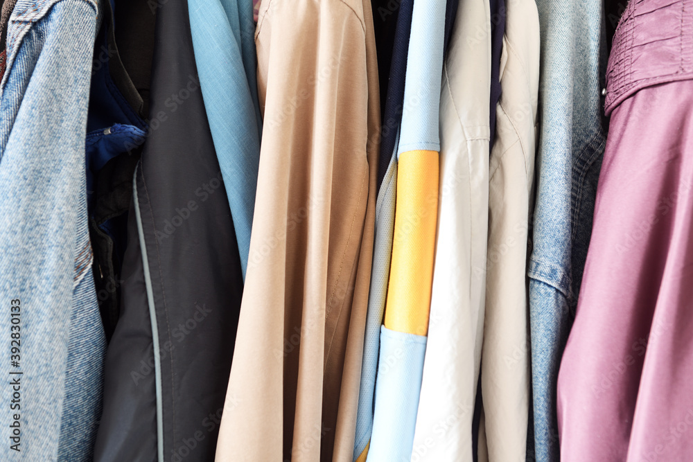 Old outerwear hangs in a row on hangers from the 1980s and 1990s. Old outerwear hangs in a row on hangers from the 1980s and 1990s.