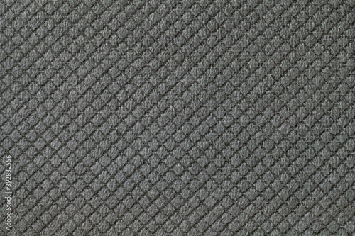Texture of dark gray fluffy fabric background with rhomboid pattern