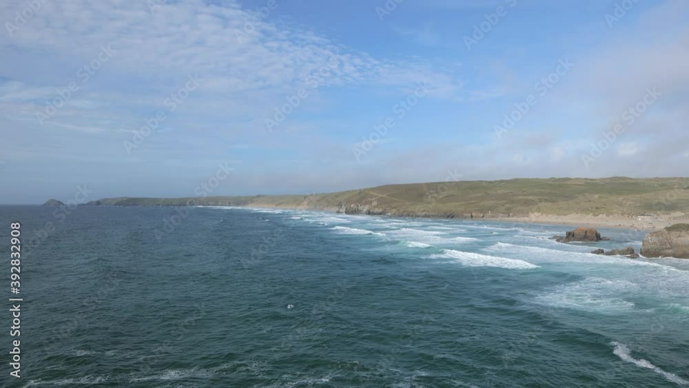 A view of the Cornish coast from a cliff top during summer time. There are some light waves. A view of the Cornish coast from a cliff top during summer time. There are some light waves.