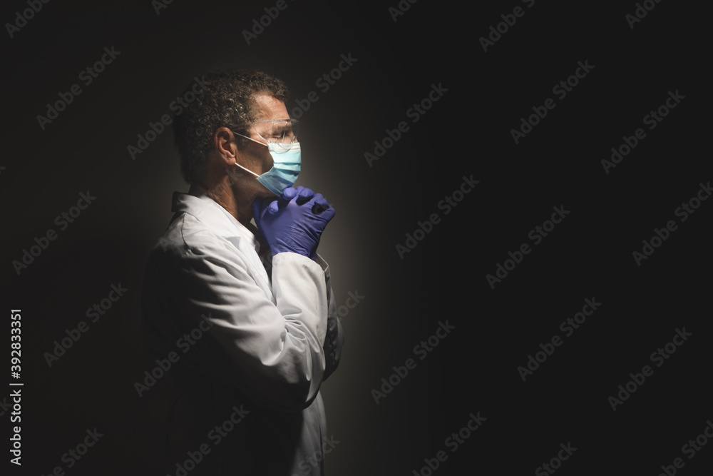 COVID Doctor Praying wearing Surgical Face Mask and Gloves COVID Doctor Praying wearing Surgical Face Mask and Gloves