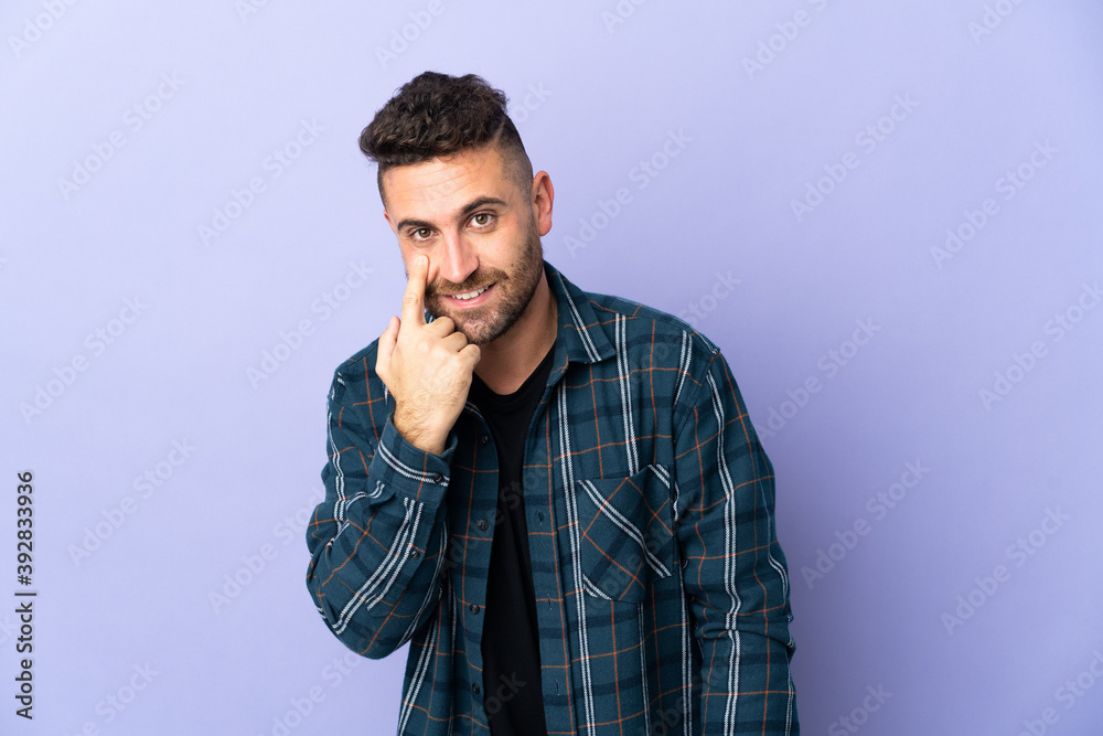 Caucasian man isolated on purple background showing something Caucasian man isolated on purple background showing something