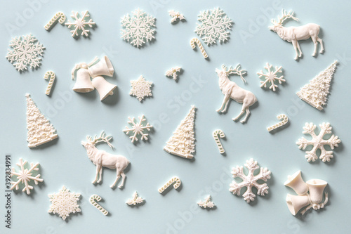 Christmas pattern of white holiday DIY decoration on blue. Xmas abstract background.