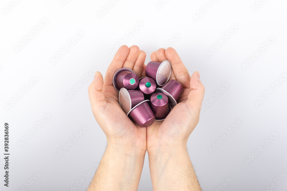 Woman's hands holding aluminum coffee capsules
Woman's hands holding aluminum coffee capsules