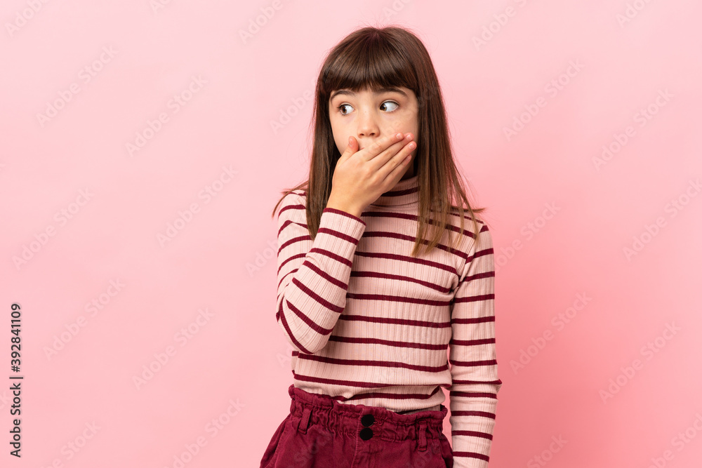 Little girl isolated on pink background doing surprise gesture while looking to the side Little girl isolated on pink background doing surprise gesture while looking to the side