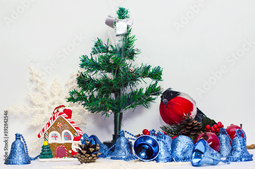 Christmas tree with gifts, a Christmas house, and a bullfinch bird