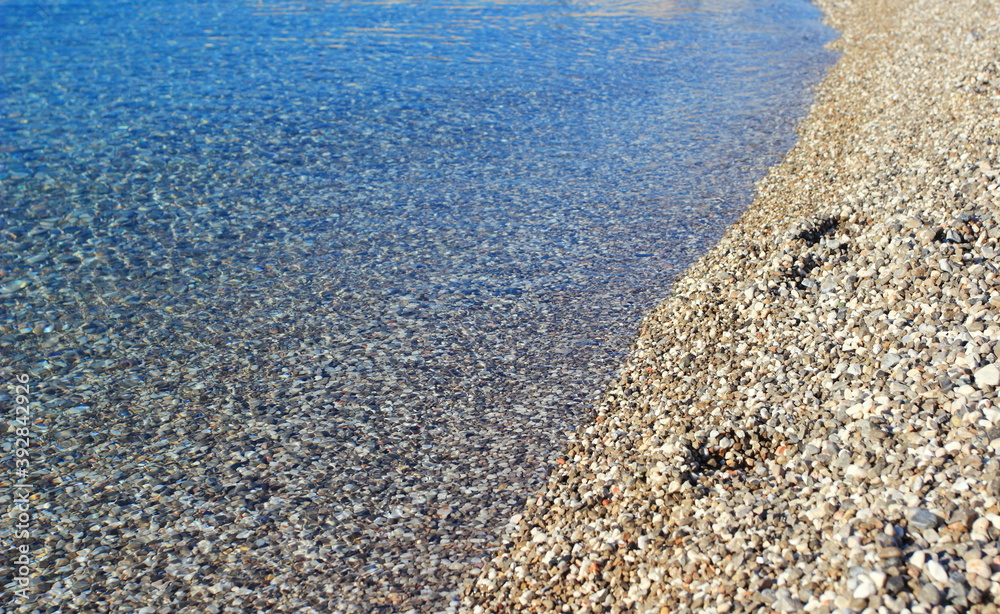Clear transparent sea with rocky pebbles bottom on the beach in town Senj, Adriatic sea, Croatia
