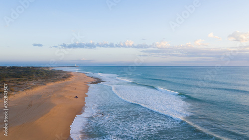 Aerial view beautiful of sea waves, sand from drone. Top view of the Faro de Trafalgar, blue water surface texture. Top view, amazing nature beach background. beach in Zahora, Cadiz, Andalusia, Spain.